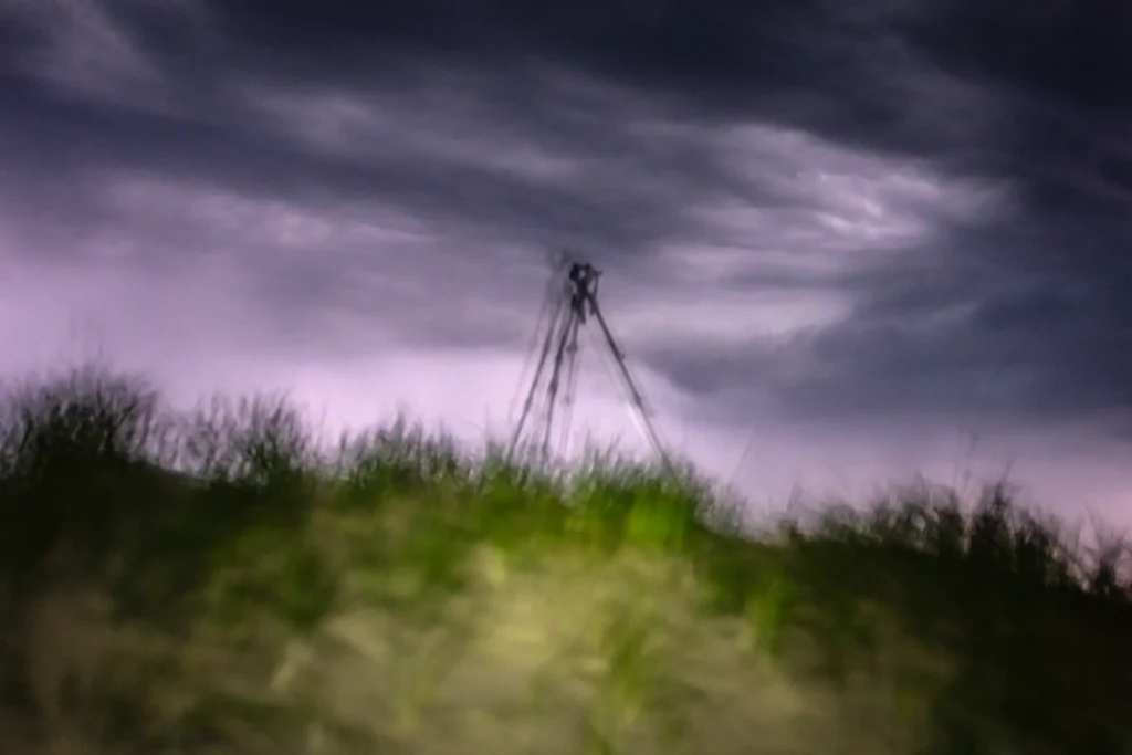 Additional photograph made by Brian Kaufman while working on "Dark & Stormy" nature-in-motion piece shows the photographer's tripod on the dune top as a lightning storm approaches