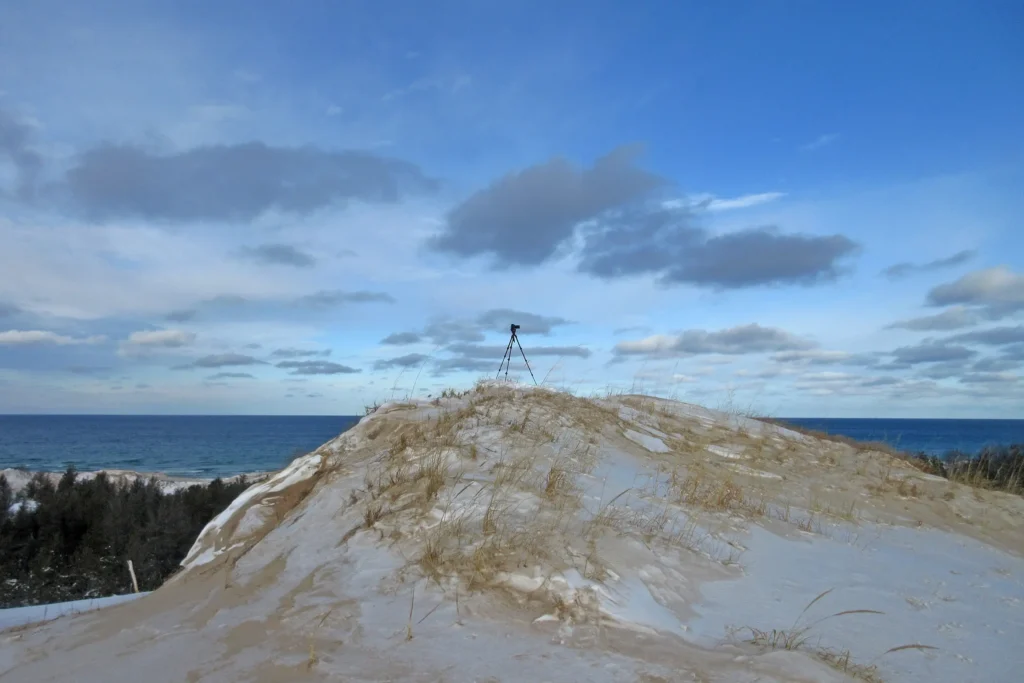 Additional photograph made by Brian Kaufman while working on "Dark & Stormy" nature-in-motion piece shows the photographer's tripod on the dune top mid-winter.