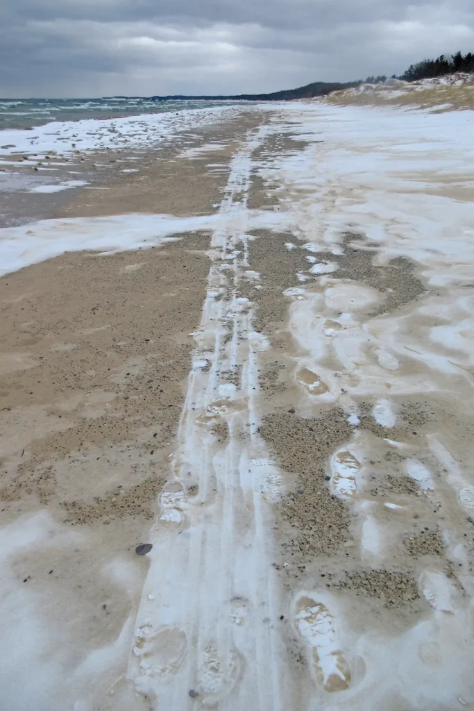 Additional photograph made by Brian Kaufman while working on "Dark & Stormy" nature-in-motion piece shows a sled track through snow and sand.