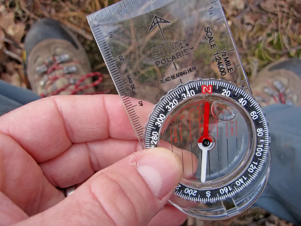 Additional photograph made by Brian Kaufman while working on "The Trumpeter" nature-in-motion piece shows him using a compass en route to Penoyer Lake
