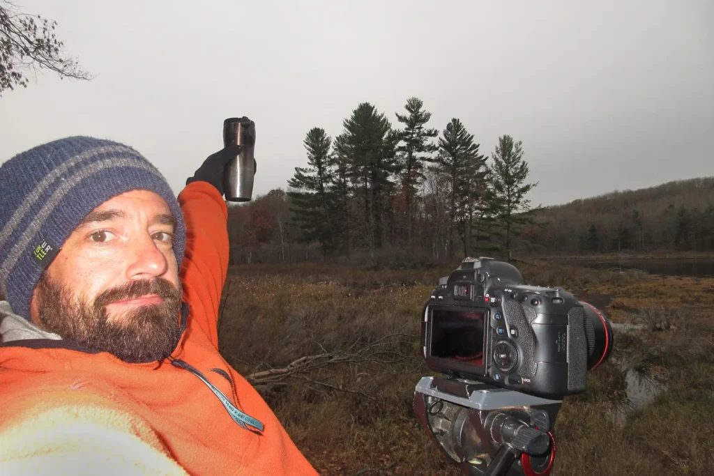 Additional photograph made by Brian Kaufman while working on "The Trumpeter" nature-in-motion piece shows him standing by the tripod